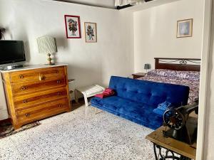 uma sala de estar com um sofá azul e uma cama em Casa Palazzo Civitanova em Civitanova del Sannio