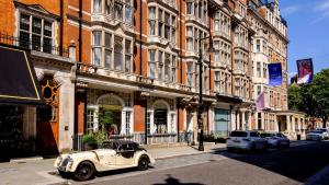 an old car parked in front of a building at Soho - Mayfair Luxury Central Apartment in London