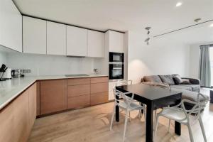 a kitchen and living room with a table and a couch at Soho - Mayfair Luxury Central Apartment in London