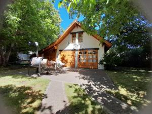 a house with a large garage with at Casa de Huéspedes Silvana in San Martín de los Andes