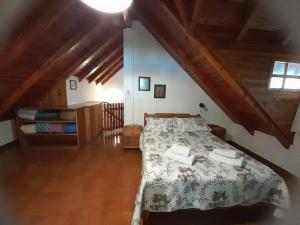 a bedroom with a bed in a room with wooden ceilings at Casa de Huéspedes Silvana in San Martín de los Andes