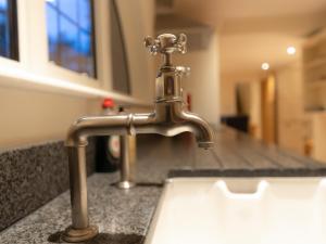 a kitchen sink with a faucet on a counter at The Turret in Wisley