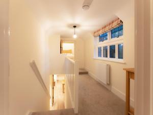 a hallway with a staircase in a house at The Turret in Wisley