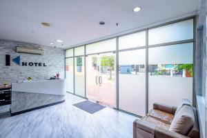 a lobby of a hotel with a couch and a counter at K Hotel 12 in Singapore