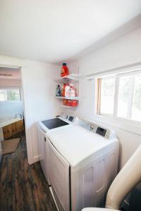 a small kitchen with a washer and dryer in it at Lakefront Stunning Home, only 30 min to Sugarloaf! in New Portland