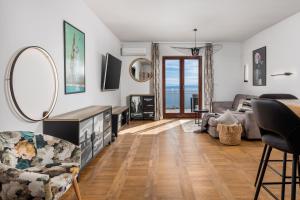 a living room with a couch and a table at Apartment Mak in Opatija