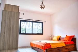 a bedroom with a bed and a window at RESIDENCE SAPHIR in Mahajanga
