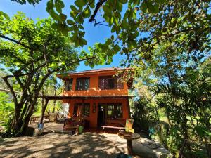 a small house in the middle of a forest at Casa Terra in Sámara