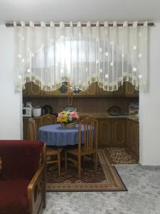 a dining room with a table with a blue table cloth at Armand's home in Korçë