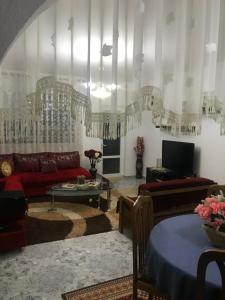 a living room with a couch and a table at Armand's home in Korçë