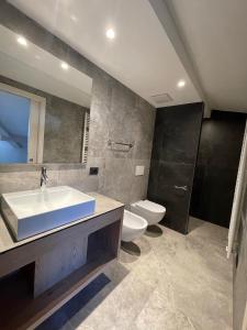a bathroom with a sink and a toilet and a mirror at Al Marchior in Andalo +22 photos