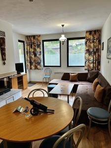 a living room with a table and a couch at Christina Apartment in Laplandia in Pamporovo