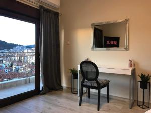 a chair sitting in front of a desk with a mirror at Panoramic suite in Kastoria