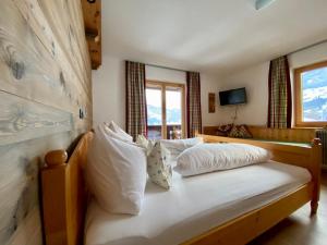 a bedroom with a bed with white pillows at Ferienhaus Oberhuben in Fügenberg +115 photos