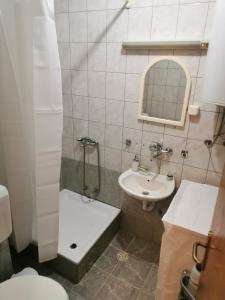 a bathroom with a sink and a shower and a toilet at 007 Apartments - TC Global, Strumica, Macedonia in Strumica