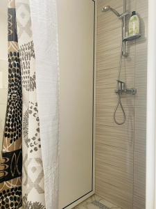 a shower in a bathroom with a shower curtain at Hostel OT in Split