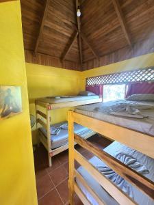 a room with three bunk beds in a house at Casa Terra in Sámara