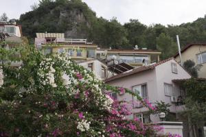a group of buildings with flowers in front of them at Perle House in Fethiye