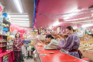 a group of people standing at a counter in a store at Iwayu in Misasa
