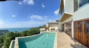 a house with a swimming pool with a view of the ocean at High Life Villas in Salad Beach