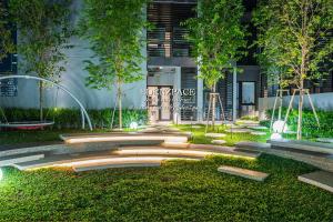 a garden with a fountain in front of a building at Scarletz Suites by Edenzpace @ KLCC Area in Kuala Lumpur