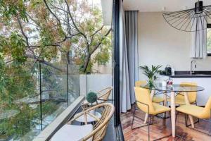 a dining room with a table and chairs on a balcony at Luxury 3 Bedrooms Apt near Hilton hotel in Tel Aviv