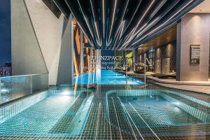 a swimming pool on the top of a building at Scarletz Suites by Edenzpace @ KLCC Area in Kuala Lumpur