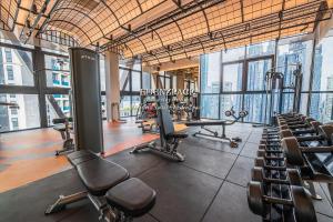 a gym with chairs and machines in a building at Scarletz Suites by Edenzpace @ KLCC Area in Kuala Lumpur