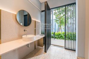 a bathroom with a sink and a mirror at Scarletz Suites by Edenzpace @ KLCC Area in Kuala Lumpur