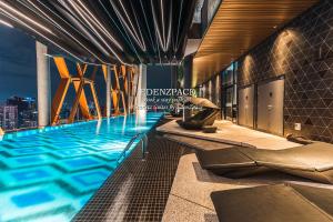 a swimming pool in a building with a city skyline at Scarletz Suites by Edenzpace @ KLCC Area in Kuala Lumpur