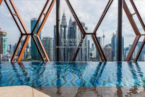 a swimming pool with a view of the city at Scarletz Suites by Edenzpace @ KLCC Area in Kuala Lumpur