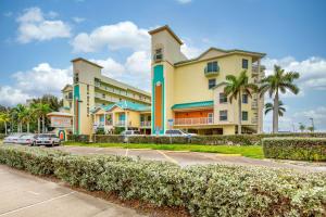 a large building with cars parked in a parking lot at Sunset Vistas 206S in St Pete Beach