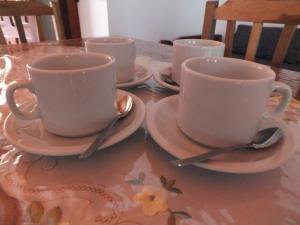 three coffee cups and saucers on a table at Madre Selva Iguazu in Puerto Iguazú +32 photos