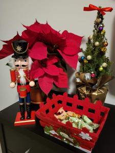 a figurine of a nutcracker next to a christmas tree at A casa da Cri B&B in Rome