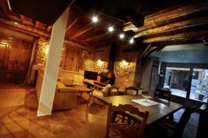 a living room with a table and a couch at La Solana de Aldeasoña in Aldeasoña