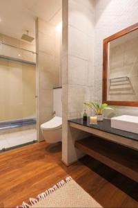 a bathroom with a sink and a toilet and a mirror at Studio 474 in Colombo