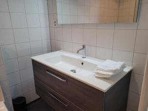 a bathroom with a sink with towels on it at L'appel Studio near Amsterdam in Warder
