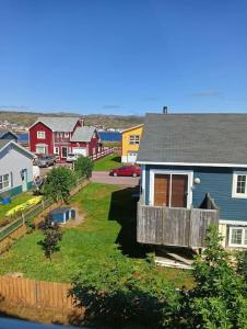 a house with a deck in a residential neighborhood at Les Aigus in Saint-Pierre