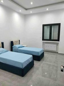 Кровать или кровати в номере Appartamento di lusso in Tunisia