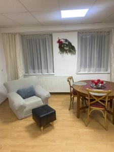 a living room with a table and a white couch at Aparmánový byt v centre Banskej Bystrice & free parking in Banská Bystrica