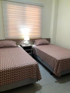 Cama o camas de una habitación en Garzota Garden PB