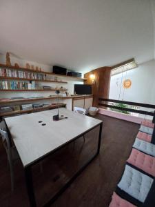 a room with a table and chairs in a room at HOSTEL Recanto do Cajueiro in Maceió