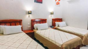 Rúm í herbergi á Hôtel Atenas