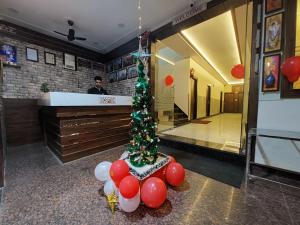 a christmas tree in the lobby of a store at Taj Nice Point Manage by Taj Sunrise Group in Agra