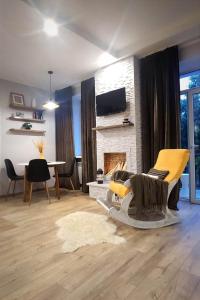 a living room with a couch and a fireplace at Stylish apartment in the historic center in Chernihiv