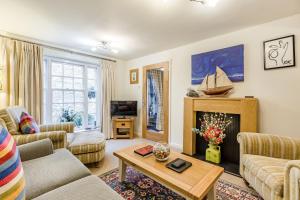 a living room with a couch and a fireplace at 138E Old Star & Garter Mews in Ludlow