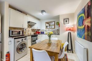 a kitchen with a wooden table and white appliances at 138E Old Star & Garter Mews in Ludlow