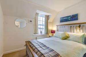 a bedroom with a bed and a window at 138E Old Star & Garter Mews in Ludlow