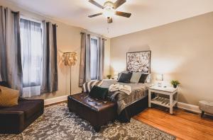 a bedroom with a bed and a ceiling fan at Chic & Cozy City Living Enjoy Baltimore in Style in Baltimore