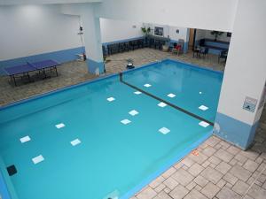an empty swimming pool with blue lights on it at Yafe Nof 35 in Ashqelon